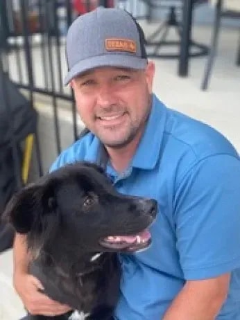 Justin Ruiz Counselor with dog